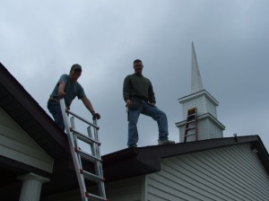 Workers siding the steeple